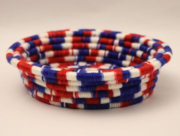 Handwoven basket in red, white, and blue colors.