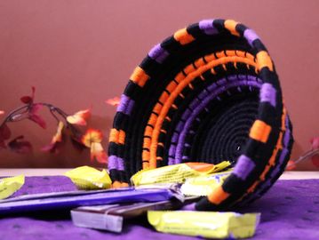 Handmade Halloween Clothesline and yarn coil basket in black, orange, and purple colors.