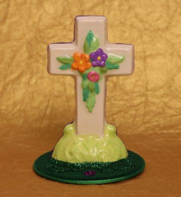Decorative cross with colorful flowers on a green base.