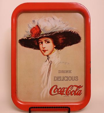 Vintage Coca-Cola tray with elegant woman in large hat.
