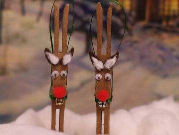 Two handcrafted reindeer decorations with red noses and googly eyes.