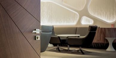 Modern interior door with geometric design and sleek handle, opening to a stylish lounge 