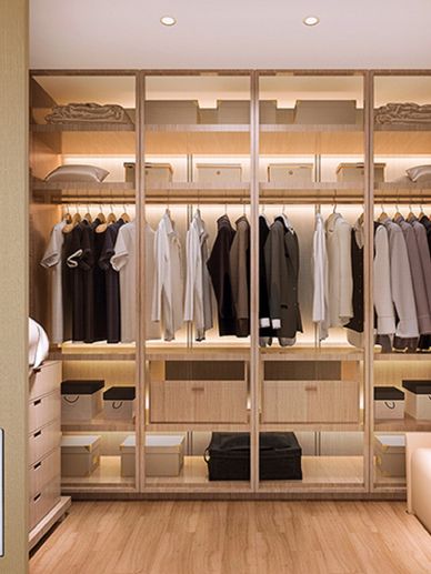 Custom wood wardrobe with glass doors, LED lighting, and organized luxury closet storage.