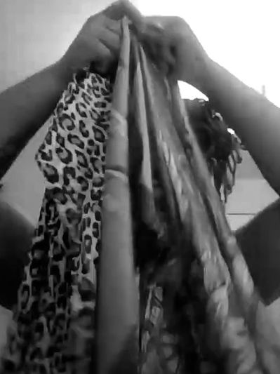 Tyvon holding up scarfs