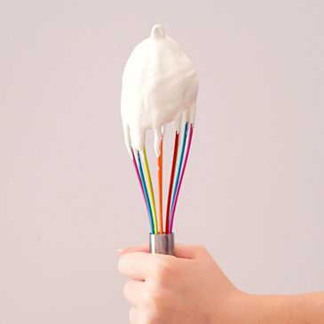 colorful whisk with cream on it