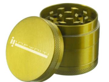 A gold metal herb grinder.