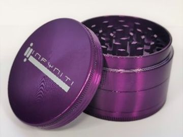 Purple metal herb grinder with logo on the lid.