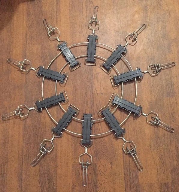 Circular arrangement of metal clamps on a wooden surface.