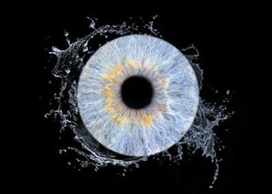 Close-up image of an eye with water splashing around it.