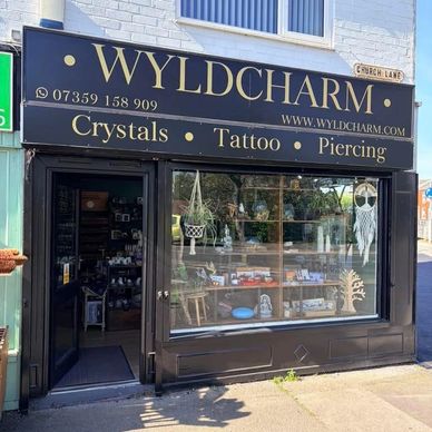 Black and gold shop front of one of our drop off/collection points - Wyldcharm who do tattoos, pierc
