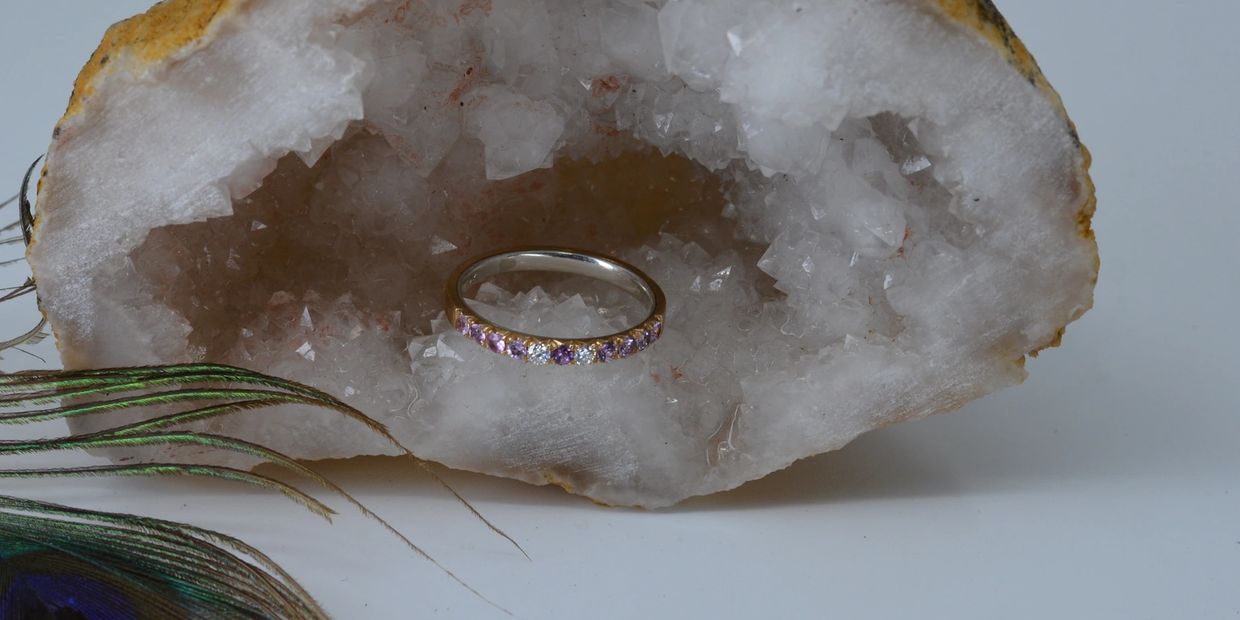 French cut fish tail setting with purple spinels on 14k gold ring with silver lining inside of ring.