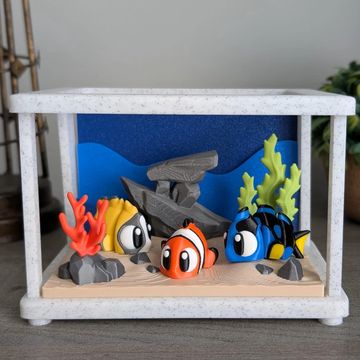 Tropical fish desk pet with reef-inspired habitat and vibrant ocean themed decor.