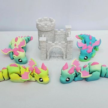 Pastel articulated mini dragon with optional castle pen holder and fantasy desk decor.