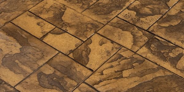 Brown textured stone tiles arranged closely together.