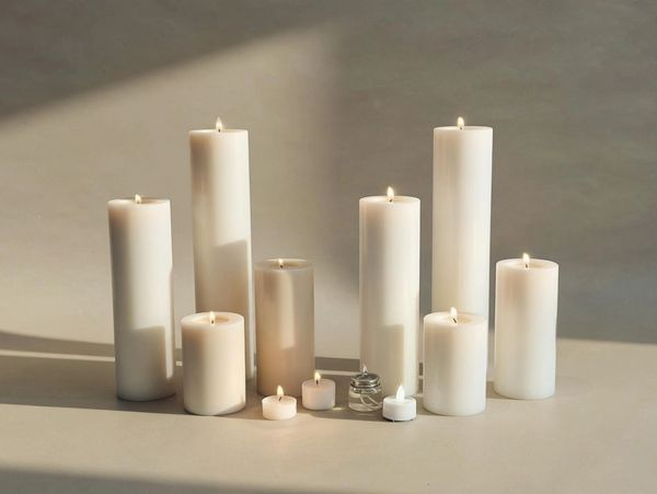 Group of lit white perfect pillars of varying sizes.