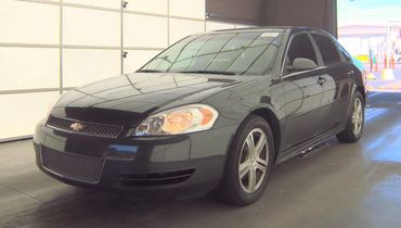 Black Chevrolet sedan parked indoors.