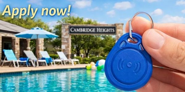 Hand holding a blue key fob by a pool at Cambridge Heights with 'Apply now!' text.