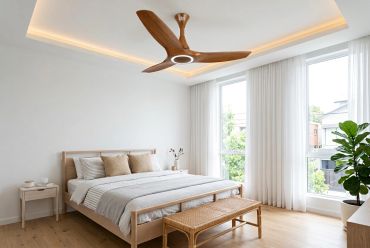 Bright bedroom with wooden furniture and ceiling fan.