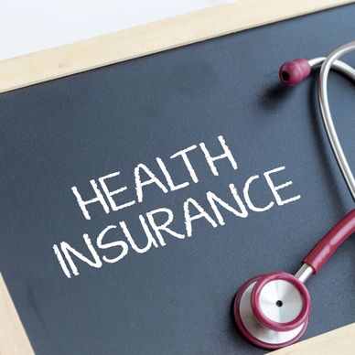 Chalkboard with 'Health Insurance' and a stethoscope.