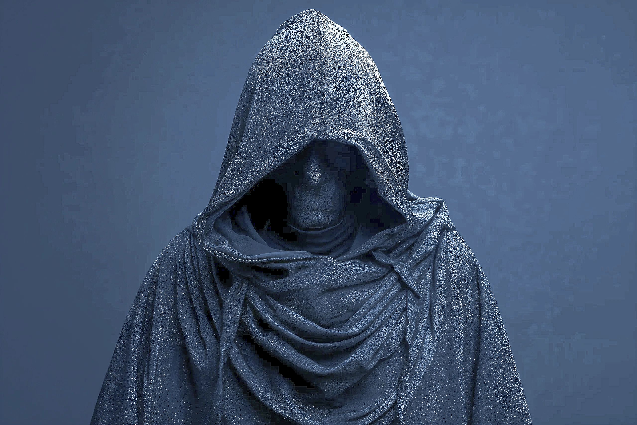 Mysterious figure cloaked in a textured, dark hooded robe with a concealed face.