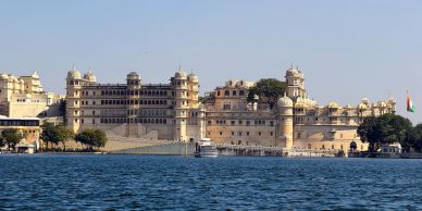 Historic palace by the water under clear sky.