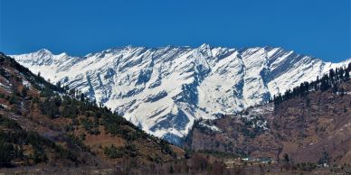 Snow-covered mountains with blue sky.