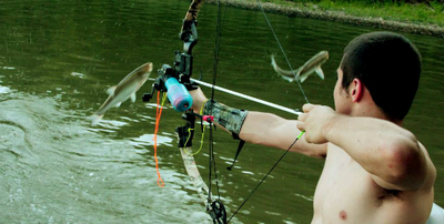 Man Hunting Fish With Bow And Arrow Attached To String Stock Photo Alamy