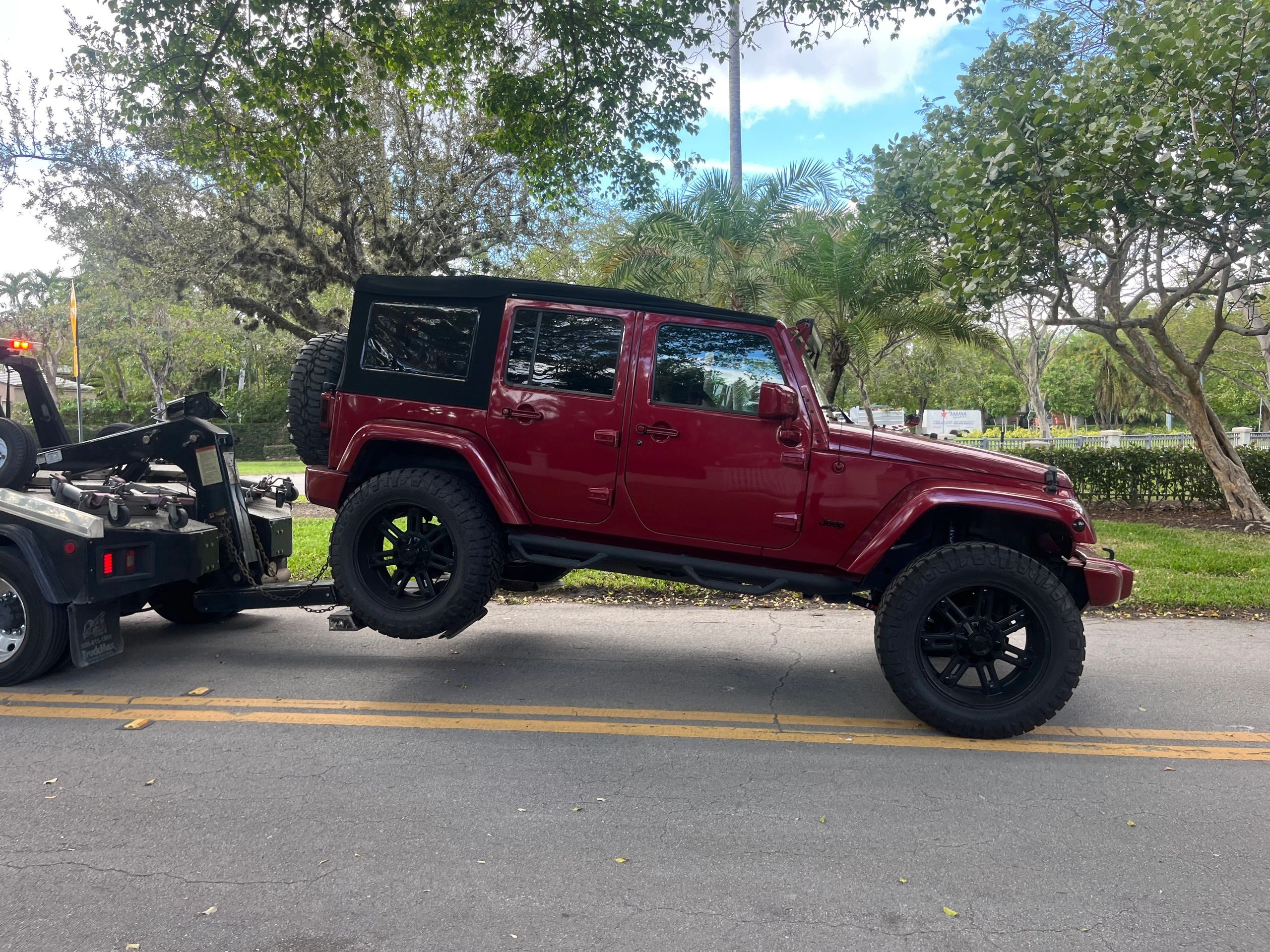 Lifted custom Jeep wrangler custom being towed near Miami