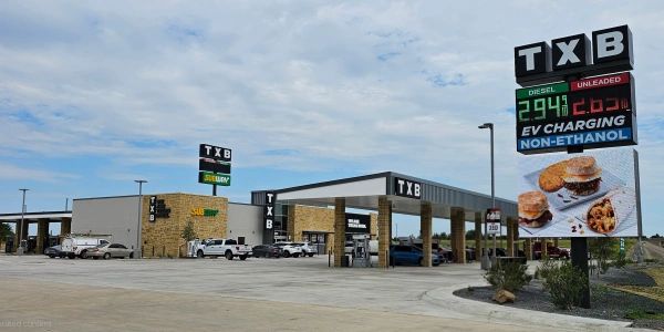 TXB gas station with fueling area and sign showing prices.