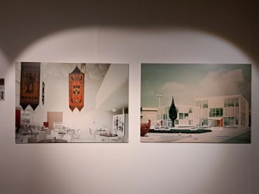 Two framed photographs displayed on a gallery wall under spotlight.