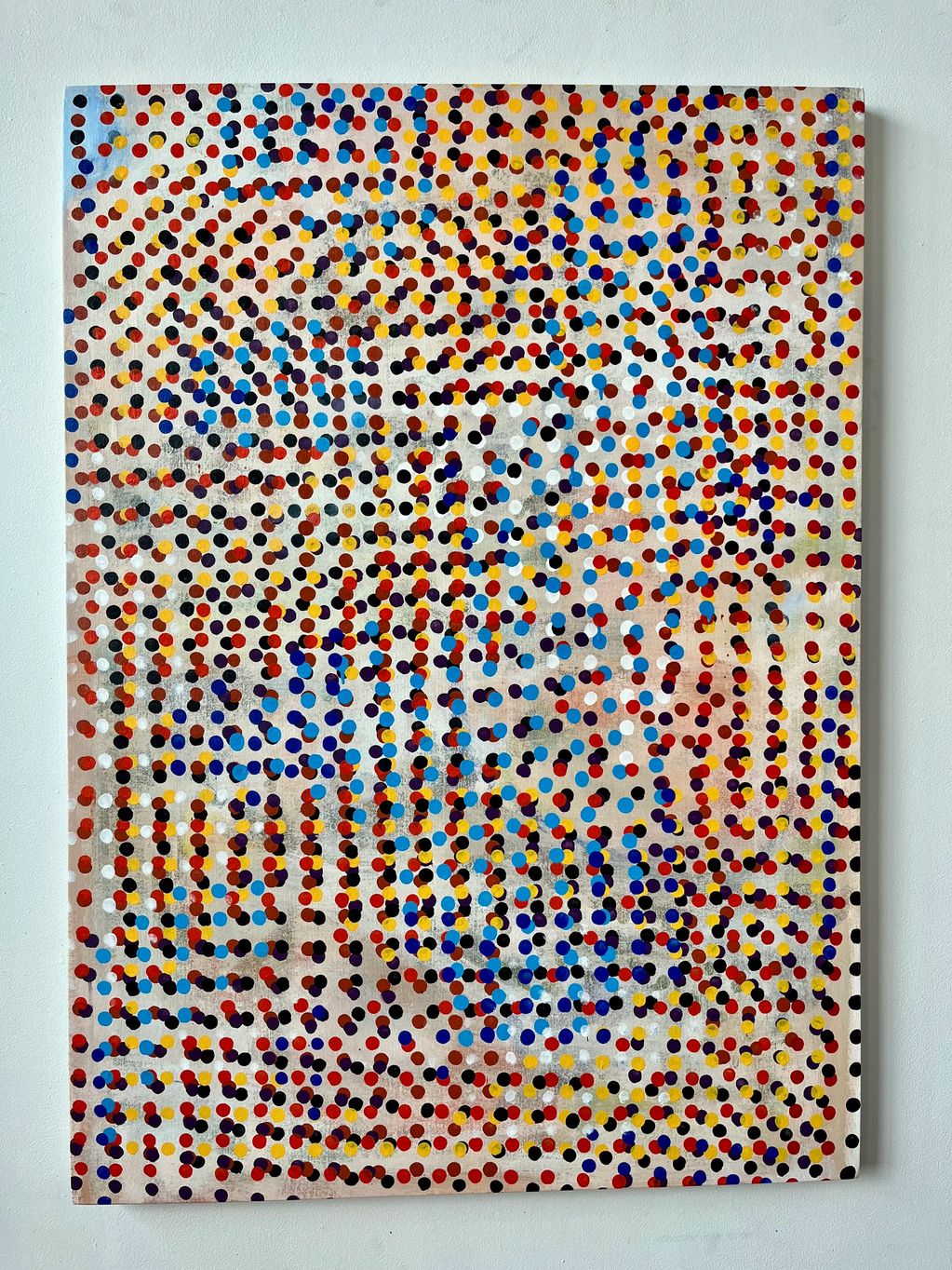 Abstract painting with colorful dots arranged in swirling patterns on a white canvas.