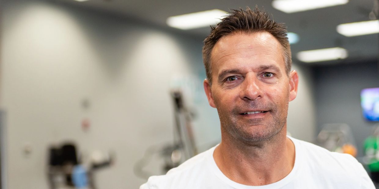 Closeup headshot of gym trainer on the display