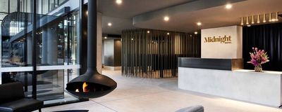 Modern hotel lobby with hanging fireplace.