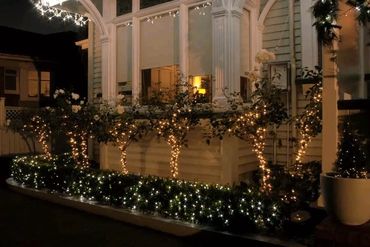 Remuera funeral home illuminated with Christmas fairy and icicle lights.
