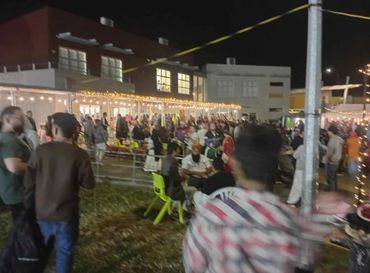 OUTDOOR EVENT LIGHTING and golden moon decoration on stage for community event in Auckland.