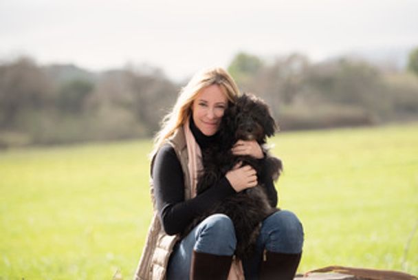 A woman sitting on the dog 