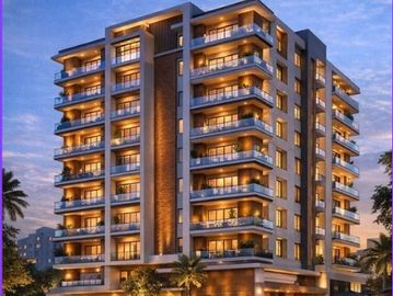 Modern multi-story apartment building illuminated at dusk.