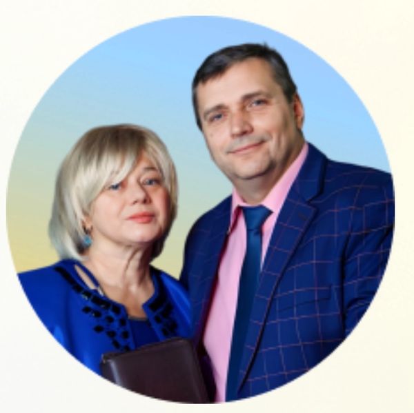 A formally dressed couple posing against a gradient background.