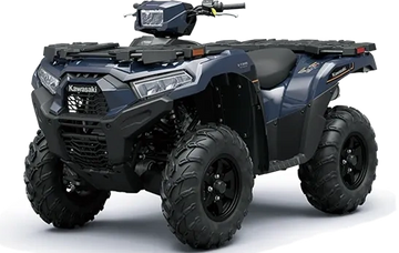 A blue Kawasaki all-terrain vehicle with rugged tires and sturdy build.