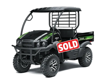 Black and green Kawasaki off-road utility vehicle with rugged tires.