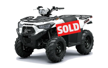 White Kawasaki ATV with a sold sign attached.
