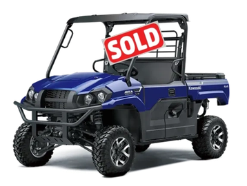Blue Kawasaki off-road utility vehicle with rugged tires and protective frame.