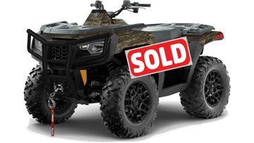 A rugged all-terrain ATV with large tires and a front winch.