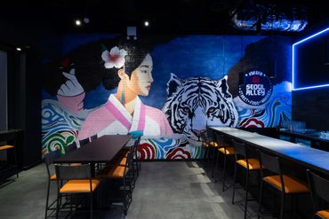 Mural of a woman and a tiger in a modern dining room.