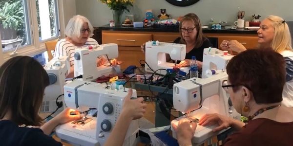 Volunteers sew reusable pads for African Sisterhood’s hygiene kits. Sew party. Sew for a good cause.