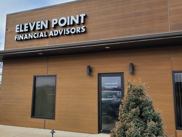 Exterior of Eleven Point Financial Advisors office with wooden paneling.