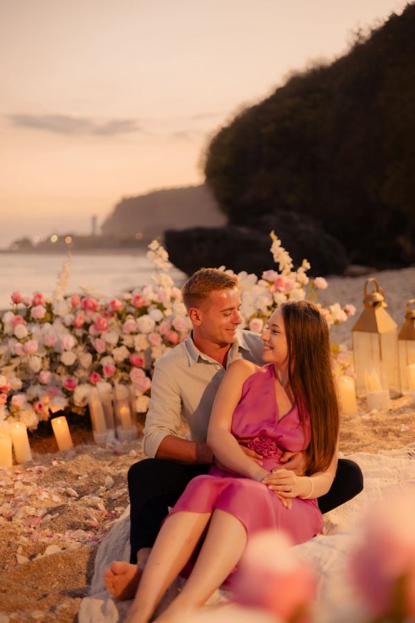 Couple enjoying a romantic beach sunset.
