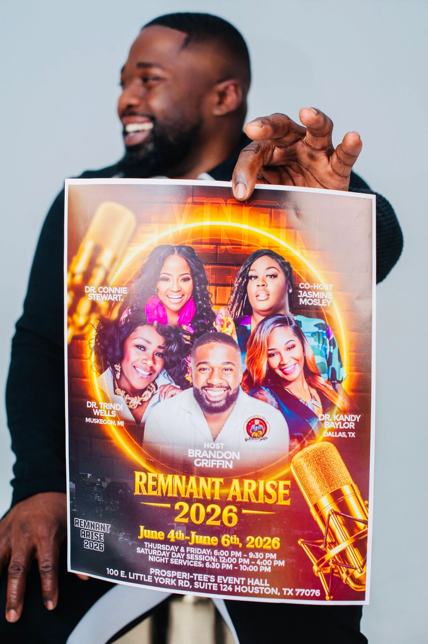 Man holding a vibrant event poster for Remnant Arise 2026 in Houston, TX.