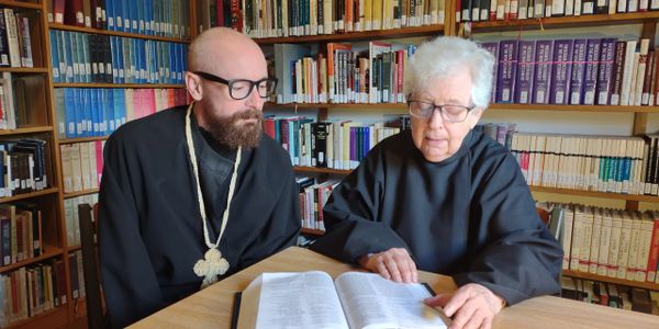 Sister Rebecca with Brother Thomas in the library.  Reading scripture together.