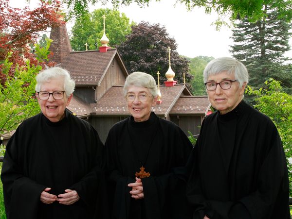 group photo of Nuns of New Skete standing in front of church
